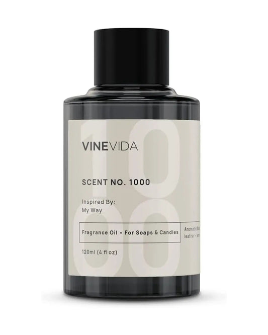 Hand holding the 4 oz Scent No. 1000 fragrance oil bottle, showing the label and amber color.