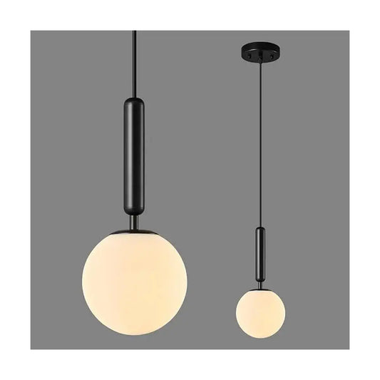 The single hanging fixture illuminated, casting a soft, diffused glow over a kitchen island.