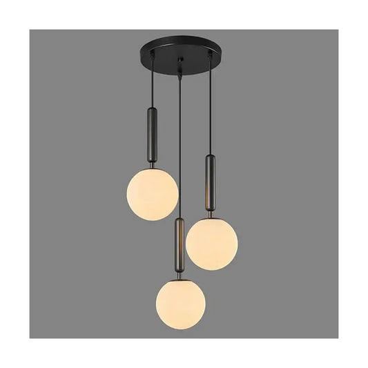 The milk white glass globe shades of the pendant light, showcasing their soft, diffused appearance.