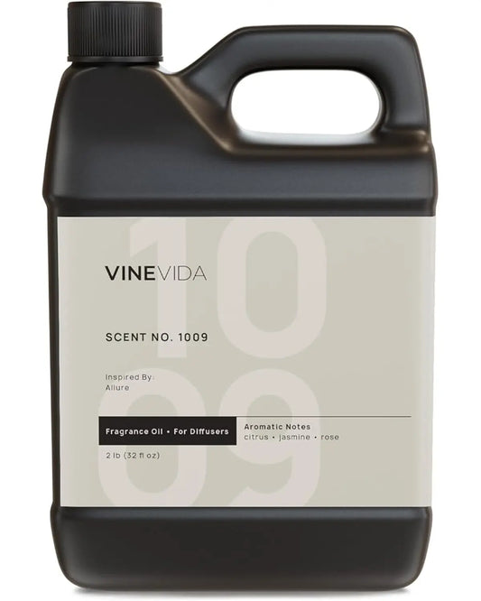 Close-up of the 32oz diffuser oil bottle label, detailing 'Scent No.1009 Inspired by Melia Hotels'.