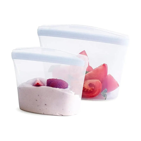 Two clear Stasher bags, one larger and one smaller, displayed on a kitchen counter.