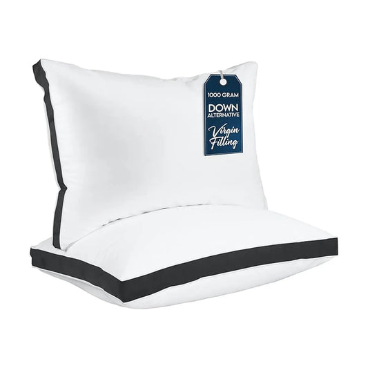 Close-up of the smooth black fabric and crisp gusseted edge of a single bed pillow.