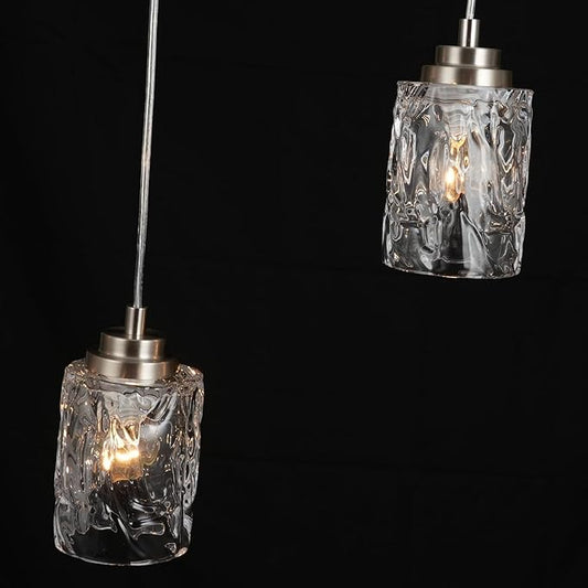 The pendant light fixture hanging above a dining table, illuminating the space with a warm glow.