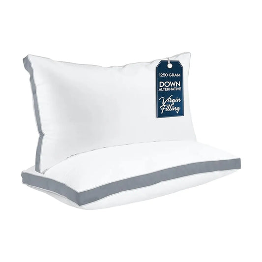 Close-up of the smooth grey fabric and crisp gusseted edge of a single bed pillow.