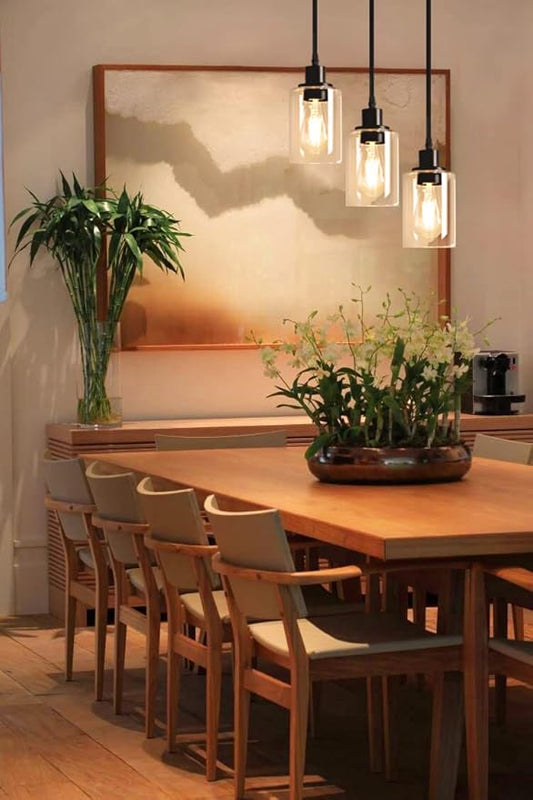 Close-up of one clear glass shade, showing its transparent quality and the exposed bulb socket.