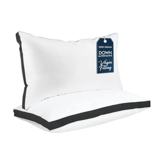 Close-up of the smooth black fabric and crisp gusseted edge of a single bed pillow.