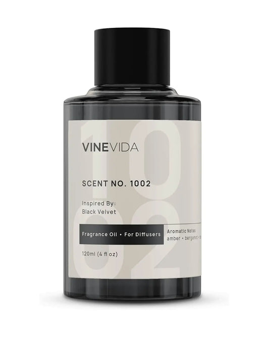 Luxury Hotel Scent No.1002 diffuser oil bottle next to a sleek cold air diffuser in an elegant room.