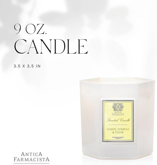 Close-up of the Antica Farmacista Lemon, Verbena & Cedar candle in its glass jar with flame.
