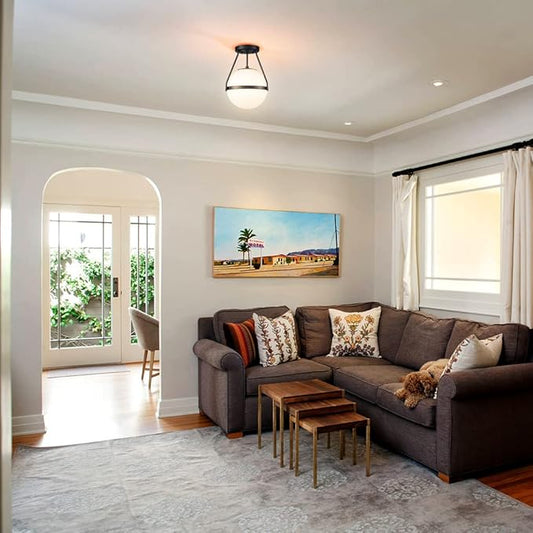 The modern light fixture showcasing white opal glass shades contrasted with black elements.