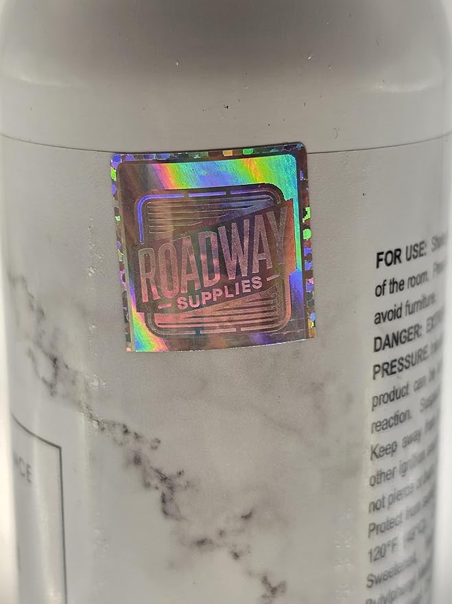 Angled view of the spray bottle, highlighting its sleek design and light color.