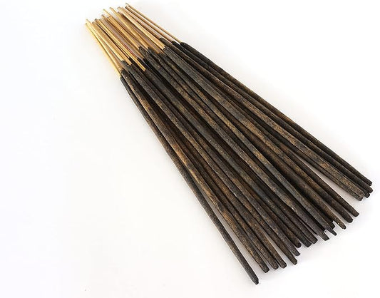 Close-up of a single handmade incense stick, showing its textured, natural composition.