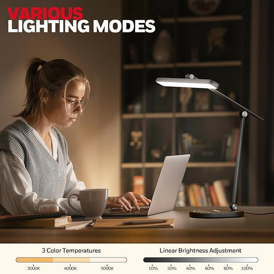 The flexible arm of the Honeywell desk lamp bent to illuminate a specific task area.