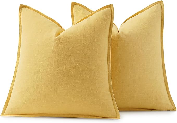 Yellow decorative pillow covers adding a vibrant, warm accent to a cozy living space.