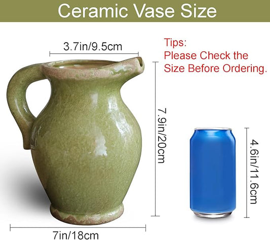 Angled shot of the terracotta pitcher vase, highlighting its handle and decorative green glaze.