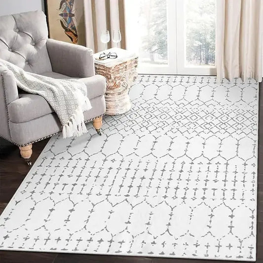 Close-up of the soft, low-pile texture and detailed white geometric Moroccan pattern on the washable rug.