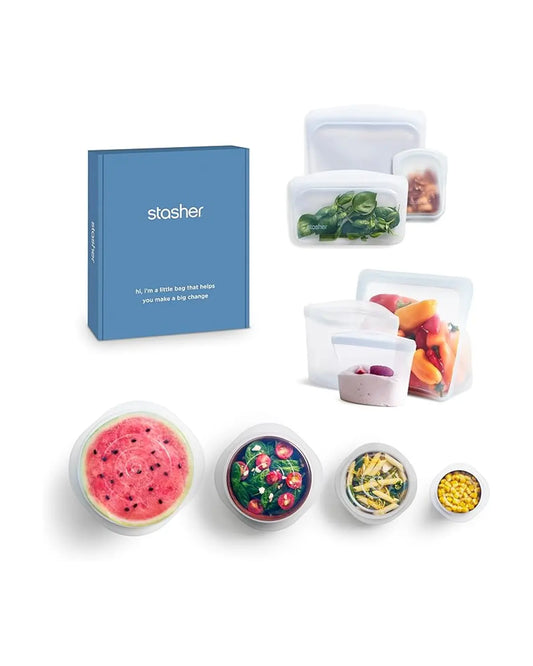 An assortment of clear Stasher silicone bags and matching stretch lids for various containers.