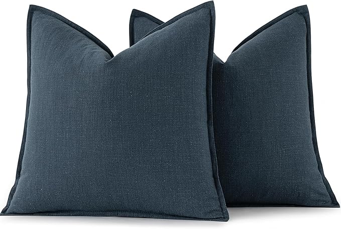 View of the reverse side of a navy blue pillow cover, showing the clean stitching and construction.