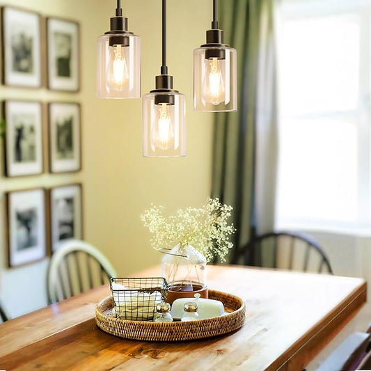 Close-up of one clear glass shade, showing its transparent quality and the exposed bulb socket.