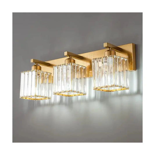 Close-up on the luxurious gold finish and sparkling crystal shades of the vanity fixture.