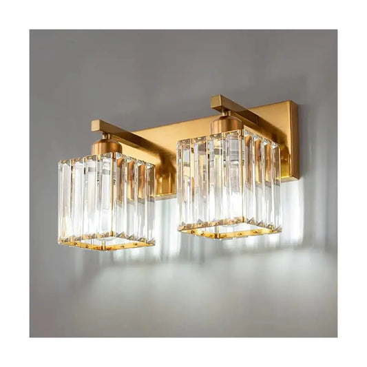 Close-up on the luxurious gold finish and sparkling crystal shades of the vanity fixture.