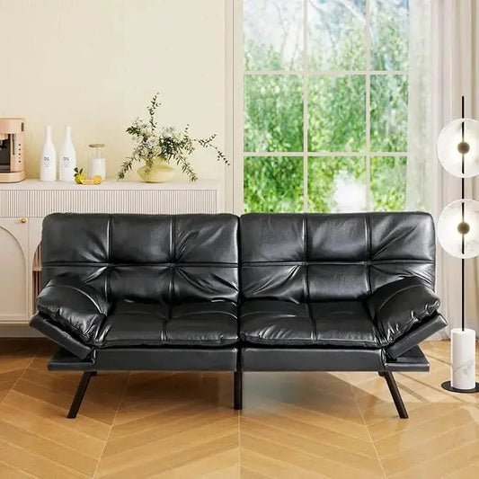 The convertible futon sofa bed in a living room, showcasing its modern design and black upholstery.