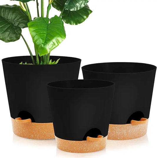 Close-up of a black self-watering plant pot, showing the water reservoir and drainage system.