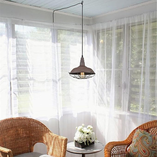 Full view of the caged pendant light, showing its long plug-in cord and switch.