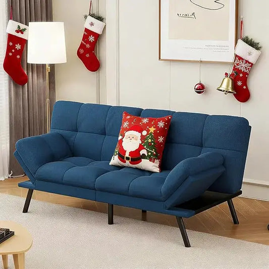 The convertible futon sofa bed in a living room, showcasing its modern design and blue upholstery.