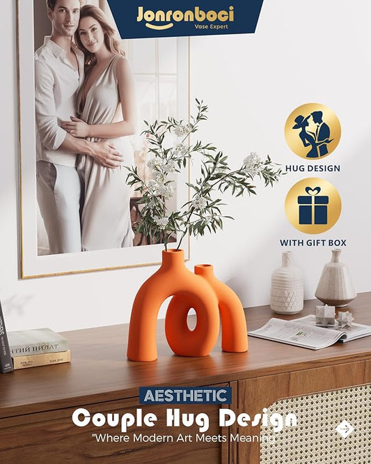 Close-up of the unique donut shape and smooth matte finish of an orange vase.