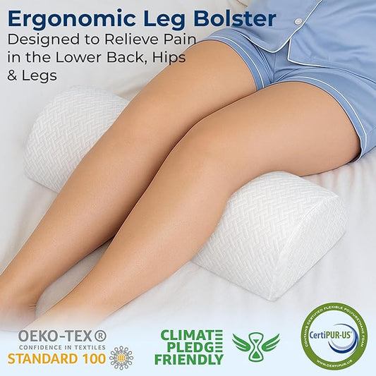 The large white knee pillow providing under-leg support for back sleeping.
