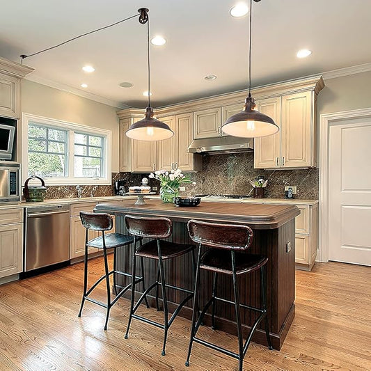 Close-up of one aged bronze pendant light, showing the vintage design and pulley mechanism.