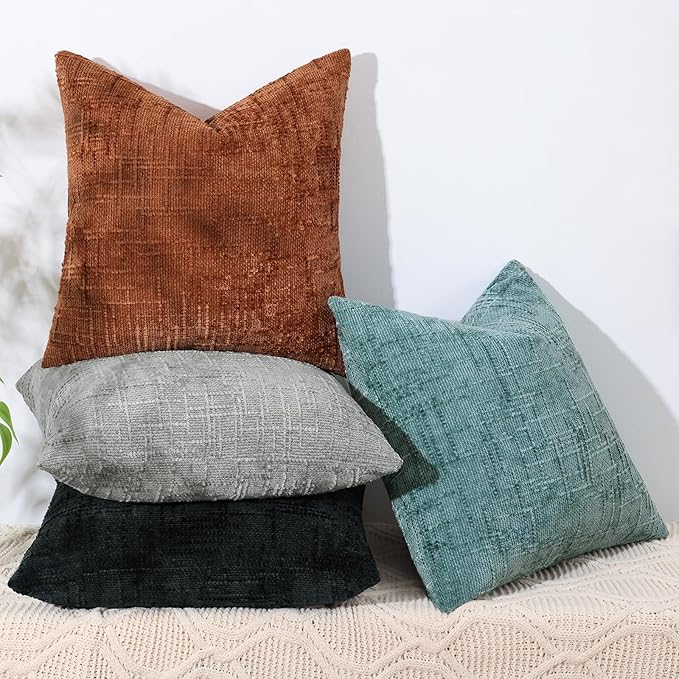 Corner detail of a black chenille pillow cover, showing the durable stitching and finish.