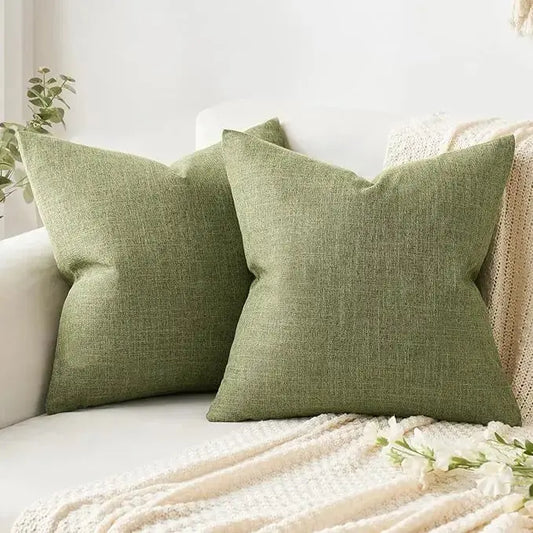 Close-up of the textured weave of the light olive green burlap pillow cover fabric.