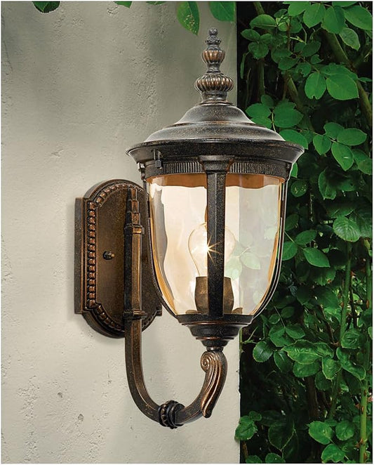 Close-up of the decorative curved arm and textured hammered glass of the outdoor wall sconce.