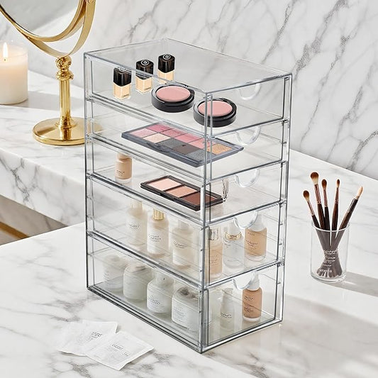 The 5-drawer acrylic organizer displayed on a vanity, filled with makeup and hair accessories.