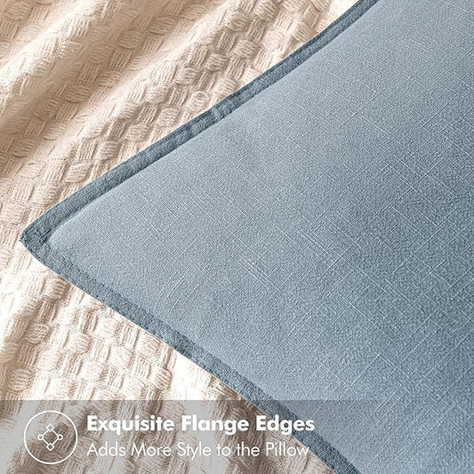 Close-up of the textured blue-grey linen fabric, showing its weave and neutral tone.