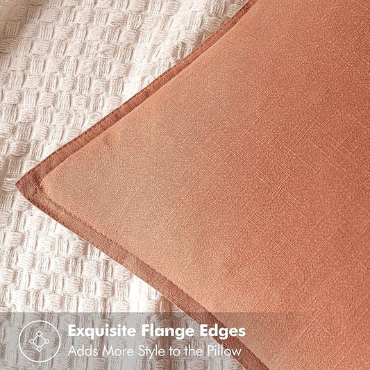 Close-up of the coral linen fabric, revealing its delicate texture and vibrant hue.