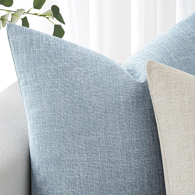 Corner detail of the light blue linen burlap pillow cover, showing stitching quality.