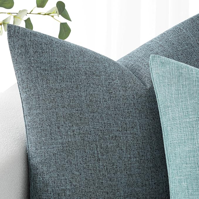 Lifestyle shot: a dusty blue throw pillow cover adding a coastal farmhouse touch to a bedroom setting.