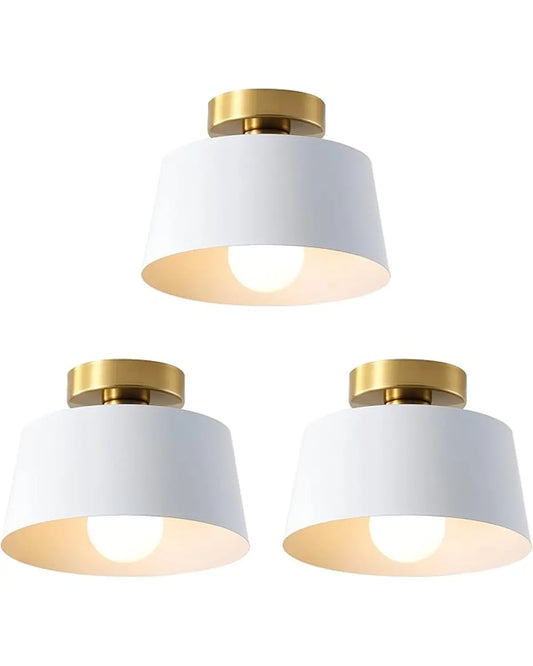Three semi-flush mount ceiling light fixtures, featuring a gold plate and a white shade, displayed as a set.