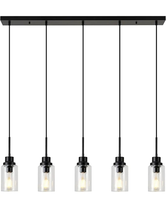 Modern black dimmable 5-light pendant fixture with clear glass shades, illuminating a kitchen island.