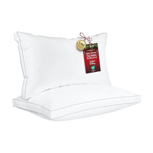 Full view of two white gusseted bed pillows stacked neatly on a clean bed surface.