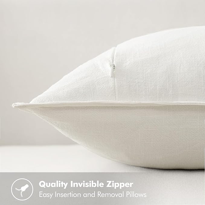Two cream white linen pillow covers neatly folded, highlighting their elegant neutral color and clean design.