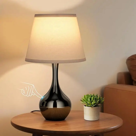 Close-up of the pearl-black table lamp, showcasing its unique finish and touch-sensitive base.