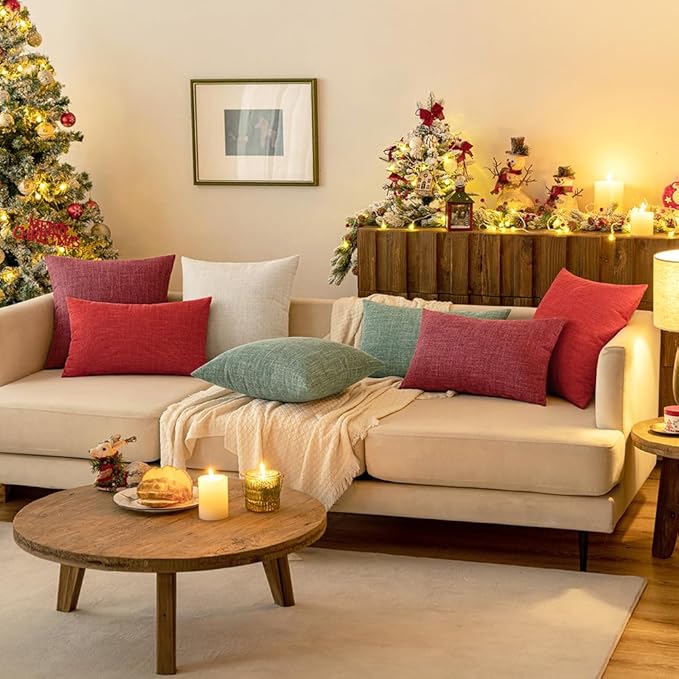 Sage green farmhouse accent pillow covers complementing a neutral living room decor.