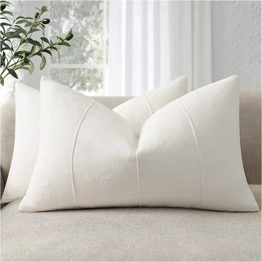 Two 12x20 cream white decorative linen lumbar pillow covers with subtle stripes, on a couch.