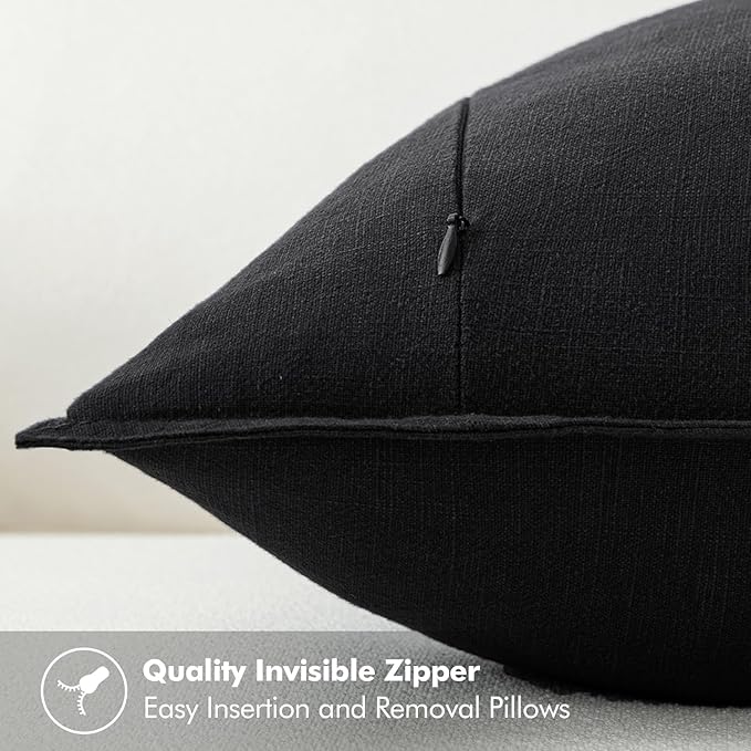 Detailed shot of the invisible zipper closure on the edge of a black pillow cover.