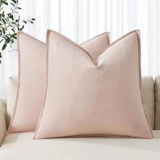 Two light pink linen euro sham pillow covers artfully placed on a couch for soft decor.