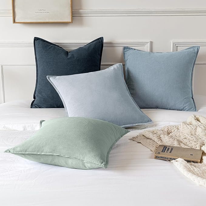 Two blue grey linen pillow covers neatly stacked, showcasing the consistent color.
