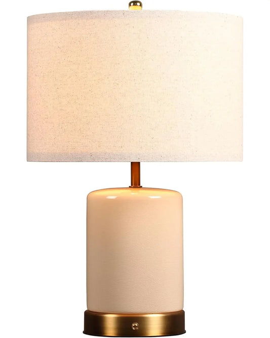 Cream white cordless ceramic table lamp with a soft glow, perfect for a bedside or living room.